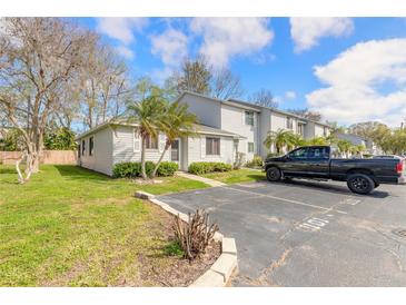 Well-maintained condo with tidy lawn, mature landscaping, and convenient parking at 1101 Deer Springs Rd, Port Orange, FL 32129