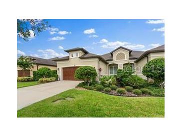 Inviting single-story home featuring lush landscaping, a two-car garage, and a neutral color palette at 3160 Bailey Ann Dr, Ormond Beach, FL 32174