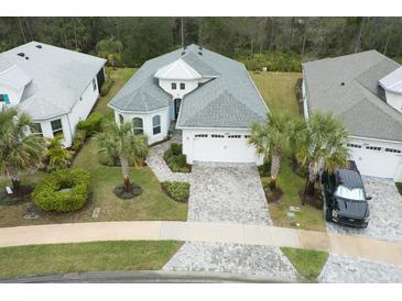 Beautifully landscaped home with a two-car garage and a well-manicured front yard with palm trees at 1068 Sea Shell Ct, Daytona Beach, FL 32124