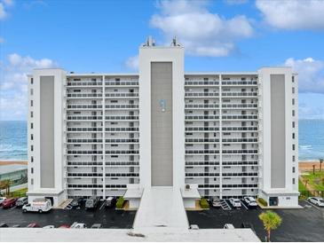 A beachfront condominium building featuring multiple floors with balconies and parking at 1155 Ocean Shore Blvd # 507, Ormond Beach, FL 32176