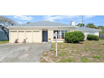 Charming single story home with manicured lawn, beautiful flower pot, and a paved driveway at 11 Briggs Dr, Ormond Beach, FL 32176
