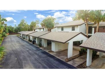 Charming condos with carport parking and landscaped grounds under a sunny sky at 1 Tomoka Oaks Blvd # 112, Ormond Beach, FL 32174