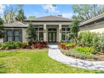 Beautiful single-story home featuring a well-manicured lawn and inviting front entrance with landscaped garden beds at 2337 Legacy Ln, New Smyrna Beach, FL 32168