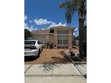 Charming single-story home with well-maintained landscaping and a two-car garage at 105 Cattail Ct, Kissimmee, FL 34743