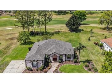 Beautiful single story home overlooking the golf course with mature trees and lush landscaping at 39601 Harbor Hills Blvd, Lady Lake, FL 32159