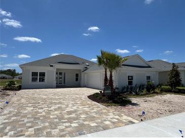 A beautifully built new construction home featuring a brick driveway and a well manicured front lawn at 1010 Megano Blvd, Deland, FL 32724