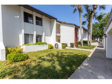 Beautifully maintained condo featuring lush landscaping and a well-manicured lawn at 1 Tomoka Oaks Blvd # 102, Ormond Beach, FL 32174