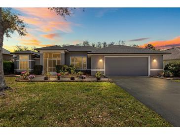 Charming single-story home featuring a well-maintained lawn and welcoming two-car garage at 6809 Plumpjack Ct, Port Orange, FL 32128