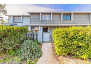 Inviting townhome entrance with a well-manicured hedge and partially enclosed courtyard at 140 Limewood Pl # 2, Ormond Beach, FL 32174