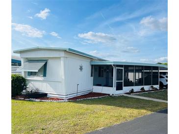 Charming single-story home with a screened-in lanai, well-maintained landscaping, and covered parking at 212 Rue De Pont, Tavares, FL 32778