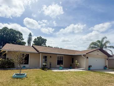 Charming single story home with a well maintained lawn and a one car garage at 2612 Umbrella Tree Dr, Edgewater, FL 32141