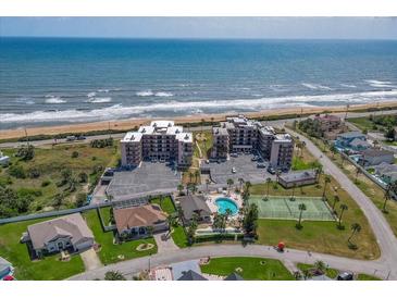 Oceanfront condo complex with amenities like a pool, tennis court, and private beach access, showcasing coastal living at 3370 Ocean Shore Blvd # 205-B, Ormond Beach, FL 32176