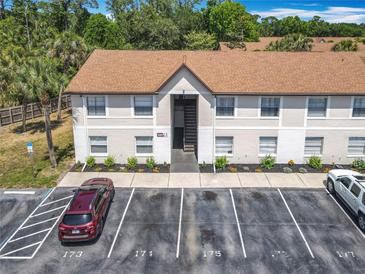 A well-maintained two-story building with ample parking spaces and neatly manicured landscaping at 420 Banana Cay Dr # A, South Daytona, FL 32119