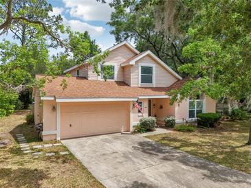 Charming two-story home features a well-maintained lawn and a two-car garage at 440 Champagne Cir, Port Orange, FL 32127