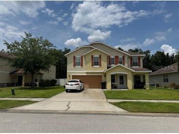 Charming two-story home featuring a two-car garage and a well-manicured lawn at 5 Cantilever Ct, Ormond Beach, FL 32174