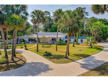 Expansive, charming home with mature landscaping, circular driveway, and unique architectural accents throughout at 1159 Magnolia Ave, Daytona Beach, FL 32114