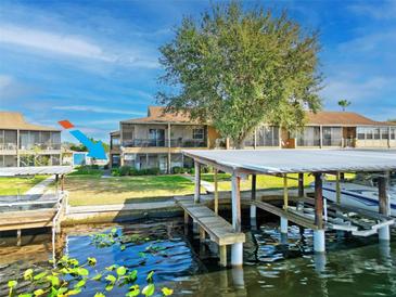 Waterfront condo featuring a boat dock and lift, perfect for enjoying lake living and recreational water activities at 1640 Juno Trl # 105D, Astor, FL 32102
