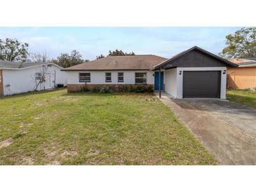 Charming one-story home with a well-maintained front yard and a one car garage at 1744 Valencia Ave, Ormond Beach, FL 32174