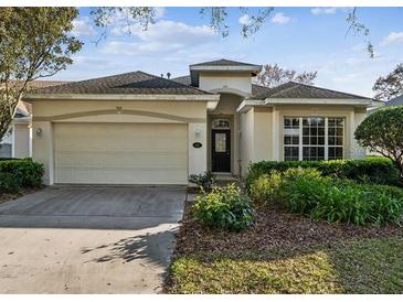 Charming single-story home featuring an attached two-car garage and well-maintained front yard at 902 Heron Point Cir, Deland, FL 32724