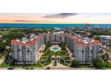 Stunning aerial view of a resort complex with a pool, lush landscaping, and the ocean in the background at 1 John Anderson Dr # 2180, Ormond Beach, FL 32176
