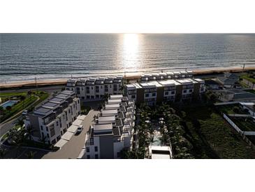 Stunning aerial view of beachfront condos with pristine coastline and lush landscaping at 2360 Ocean Shore Blvd # 2, Ormond Beach, FL 32176