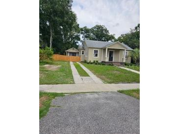 Charming single-story home featuring a welcoming front porch and a well-maintained lawn at 441 N Kentucky Ave, Deland, FL 32724