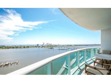 Expansive balcony view overlooking the city skyline and waterfront with comfortable outdoor seating at 231 Riverside Dr # 1602, Holly Hill, FL 32117
