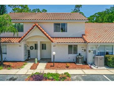 Charming two-story townhome featuring a red tile roof and welcoming front porch at 3522 Forest Branch Dr # D, Port Orange, FL 32129