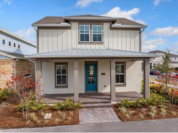 Two-story home with a covered front porch and landscaped yard at 10185 Pearson Ave, Orlando, FL 32827