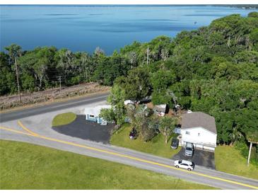 Aerial view of waterfront home with detached building and large lot at 1501 N Cr 19A, Eustis, FL 32726