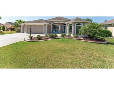 One-story home with landscaped yard, attached garage, and attractive curb appeal at 1786 Red Clover Ln, The Villages, FL 32163