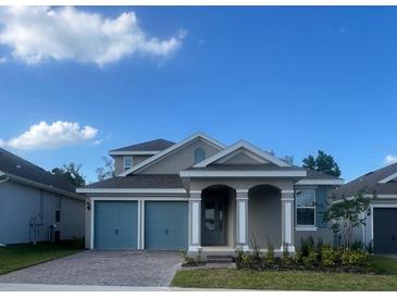 Charming two-story home with a two-car garage and inviting covered front porch at 2252 Juniper Berry Dr, Minneola, FL 34715