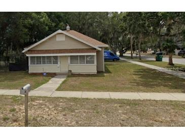 Charming single-story home with a well-maintained lawn, mailbox, and sidewalk leading to the front door at 1010 S Grove St, Eustis, FL 32726