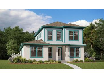 Charming two-story home featuring white stucco, teal trim, manicured lawn, and a welcoming entrance at 10430 Pearson Ave, Orlando, FL 32827