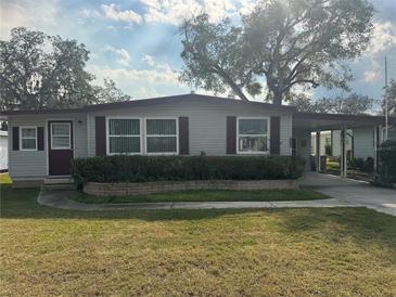Charming single-story home with well-maintained lawn and mature trees for a peaceful setting at 512 Palo Verde Dr, Leesburg, FL 34748