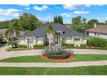 Beautiful two-story home with a landscaped yard and circular driveway at 11317 Susans Point Dr, Clermont, FL 34711