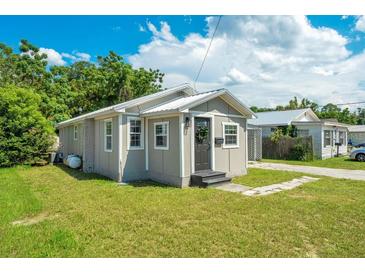 Charming single-story home with a well-maintained lawn and a neutral-toned exterior at 622 N Disston Ave, Tavares, FL 32778