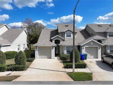 Charming townhouse with attached garage, neutral paint, manicured bushes and driveway at 115 Lake Emma Cove Dr # 1, Lake Mary, FL 32746