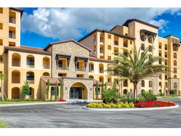 Stunning Mediterranean-style building featuring elegant stone accents, arched entryways, and lush landscaping at 16300 County Road 455 # 604, Bella Collina, FL 34756