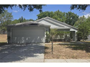 Charming single-story home with a two-car garage, well-maintained landscaping, and a classic design at 1836 Ridge Valley St, Clermont, FL 34711