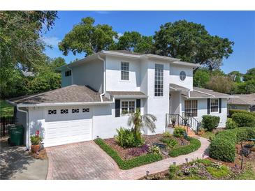 Charming two-story home with landscaped yard and brick paved driveway at 1405 Hilltop Dr, Mount Dora, FL 32757