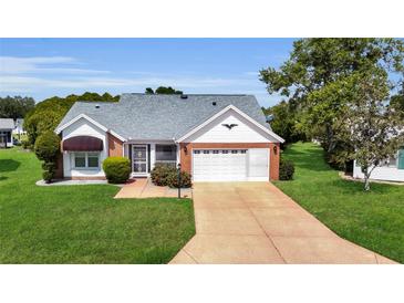 Charming single-story home with a well-manicured lawn and inviting curb appeal at 956 Chula Ct, The Villages, FL 32159