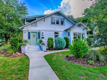 Charming two-story home with a well-manicured lawn and a light green door at 351 W 10Th Ave, Mount Dora, FL 32757
