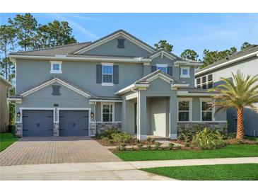 Stunning two-story home featuring a two-car garage and a beautifully landscaped front yard at 14255 Crest Palm Ave, Windermere, FL 34786