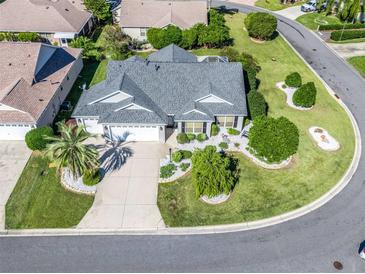 Aerial view of a single-story house with landscaped yard and two-car garage at 1315 Greenville Way, The Villages, FL 32162