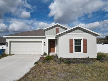 One-story house with a two-car garage and neutral colors at 361 Singing Sands Cir, Lake Wales, FL 33859