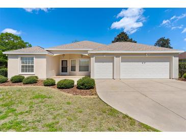 Charming single-story home featuring a well-maintained lawn and an attached two-car garage at 5009 Harbor Hts, Lady Lake, FL 32159