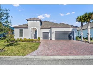Charming single-Gathering home with brick driveway and manicured landscaping at 955 Ladera Ranch Rd, Kissimmee, FL 34759