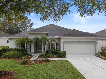 Single-story house with landscaped yard and two-car garage at 4351 Hammersmith Dr, Clermont, FL 34711