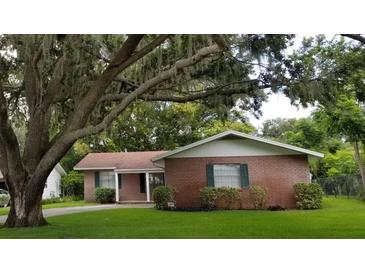 Brick house with a large tree in the front yard at 530 Mar Nan Mar Place, Clermont, FL 34711